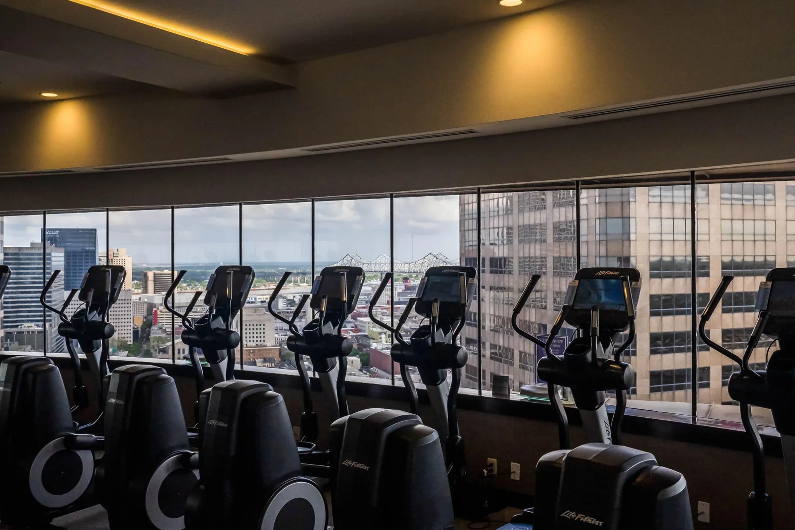 Fitness center cardio machines overlooking downtown